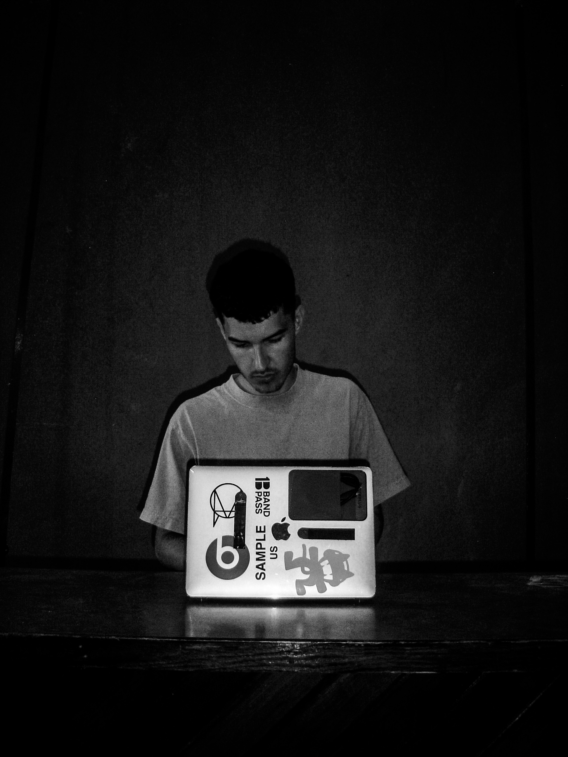 1BANDPASS seated behind a laptop